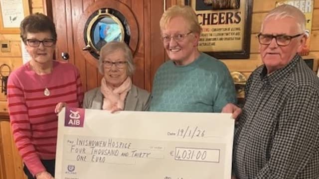Moville couple Martha and John Steele present a cheque for €4,031 to Kathleen Smyth and Gertie Monagle, of the Inishowen Hospice.
