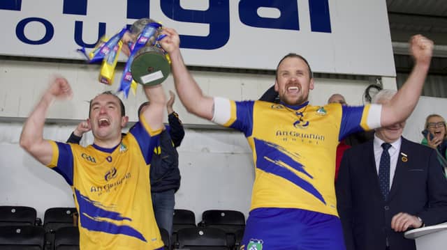 Burt joint captains Dara Grant and Stephen Gillespie raise the Ulster Junior Club Championship cup after Saturday's win over Lavey at Celtic Park in Derry
