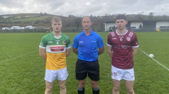 Glenswilly captain Donal Gallagher, referee Sean McDaid, and Termon captain Cormac Gallagher