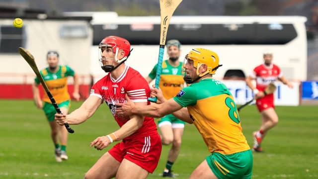 Derry's John Mullan has eyes only for the ball as Sean McVeigh of Donegal closes in. Photo: Tom Heaney