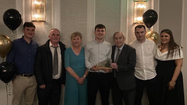 Shane O'Donnell accepts the Gradam Shéamuis Mhic Géidigh from Cathal Greene