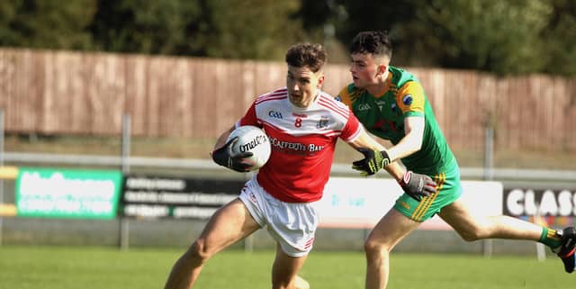 Darren Curran on the attack for Dungloe as Pauric Hegarty tackles. Photos: Thomas Gallagher