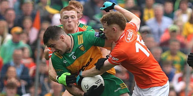 Caolan McGonagle holds possession as Armagh players surround. Photo: Thomas Gallagher