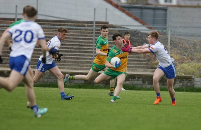 Donnchadh Ó Baoighill holds off the challenge of a Monaghan player in Fr Tierney Park, Ballyshannon Picture: Thomas Gallagher