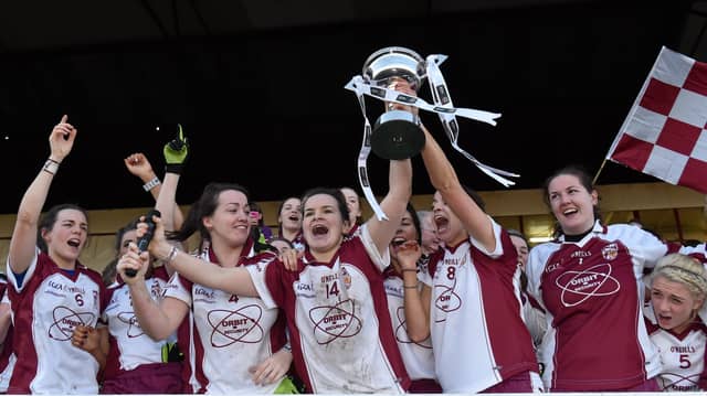 Termon captain Geraldine McLoughlin lifts the cup as her team-mates celebrate victory in the Tesco HomeGrown All-Ireland Senior Club Championship final of 2014