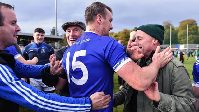 Naomh Conaill supporters spill onto the field to congratulate Leo McLoone and his teammates.