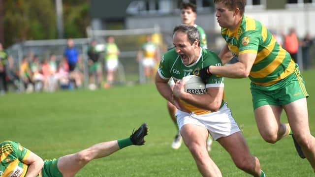 Michael Murphy on the ball for Glenswilly against Ardara's Tony Harkin. PHOTO GERALDINE DIVER