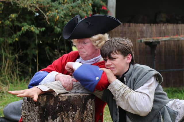 Antoin O’Doherty, right, bring tortured by a British soldier in one of the scenes from the new film, Faith of our Fathers