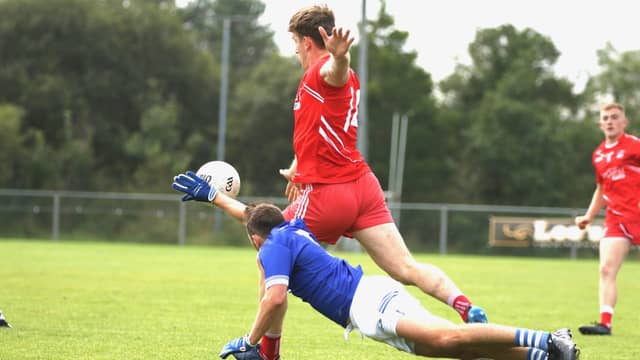 Hugh McFadden of Killybegs shoots at goal as Naomh Conaill's AJ Gallagher dives to block. Photos Thomas Gallagher