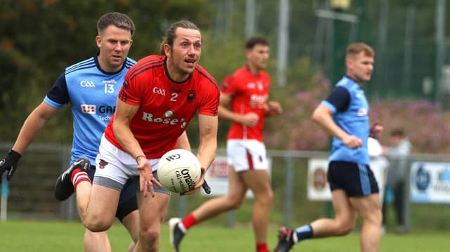 St Michael's Stephen Doak in possession as Gary Merritt of Milford closes in. Photo: Thomas Gallagher
