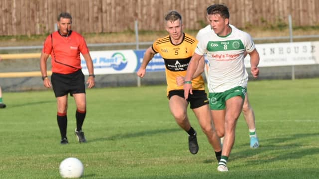 Peadar Mogan of St Naul's chased by Peter McEniff from St Eunan's at O'Donnell Park