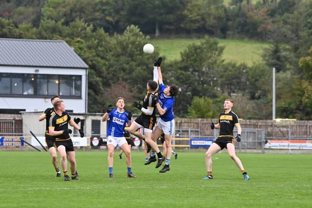 Malin and Cloughaneely players content a high ball at O'Donnell Park. Photo Bob Perry