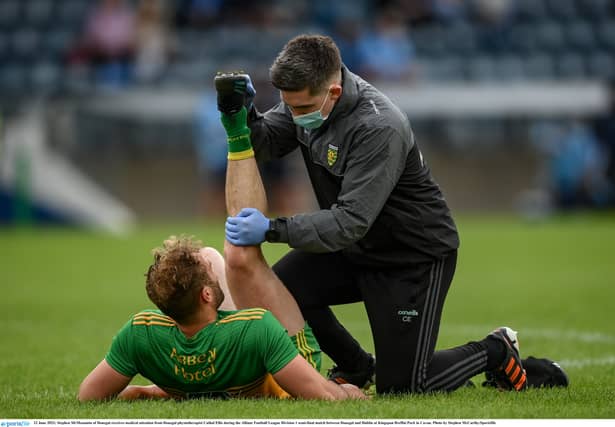 Stephen McMenamin of Donegal receives medical attention from Donegal physiotherapist Cathal Ellis during the Allianz Football League Division 1 semi-final match against Dublin at Kingspan Breffni Park