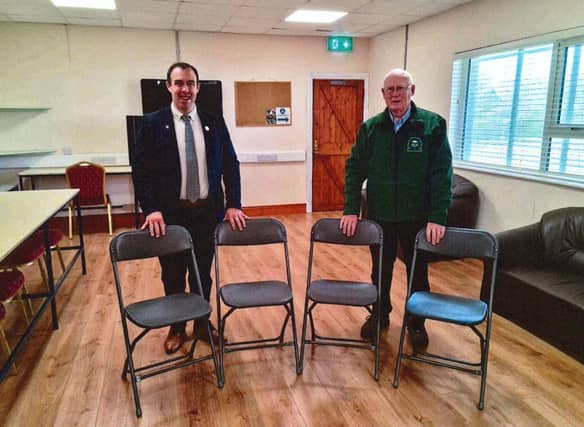 Cllr Bradley is pictured aptly presenting some chairs to chairman PJ Hallinan!