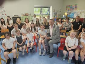 Sadhbh McBride, with classmates, receives the John Carlin Award from Sean Carlin