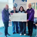 David Oliver and Gerard McGee, Finn Valley Men's Choir presenting a cheque to Caroline Ward and Katie Coleman in Alzheimer Branch Office, Ballybofey