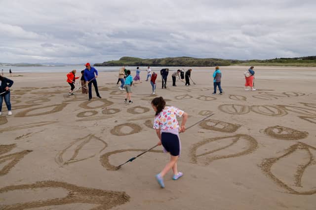 Foster families came together to create sand art at Marble Hill Beach