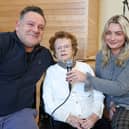 Mary Meehan sang Danny Boy at a charity coffee morning in Donegal Town to mark her 105th birthday with the help of her great granddaughter Jade and her father, Damien Silke Photo: Siobhan McGowan 
