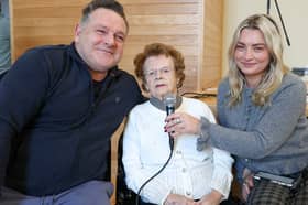Mary Meehan sang Danny Boy at a charity coffee morning in Donegal Town to mark her 105th birthday with the help of her great granddaughter Jade and her father, Damien Silke Photo: Siobhan McGowan 
