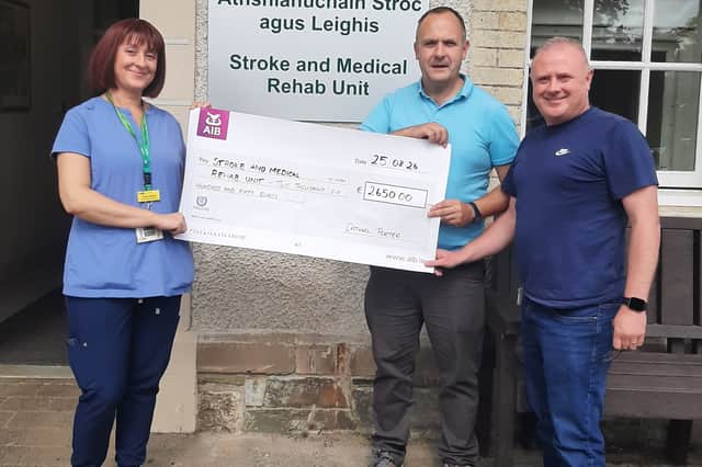 Cathal presents a cheque for €2,650 to staff at the Stroke and Medical Rehab Unit in Letterkenny.
