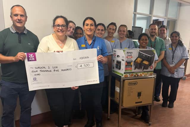 Cathal and Karen present a cheque for €4,500 to staff at Surgical 2, Letterkenny Hospital.