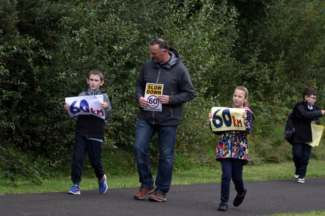 Principal at Scoil Bhríde Ciaran McDevitt protesting with his pupils