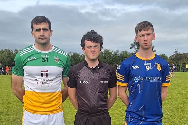 Buncrana captain Caolan McGonagle and Naomh Pádraig Darragh McIntyre with referee Martin McCormick