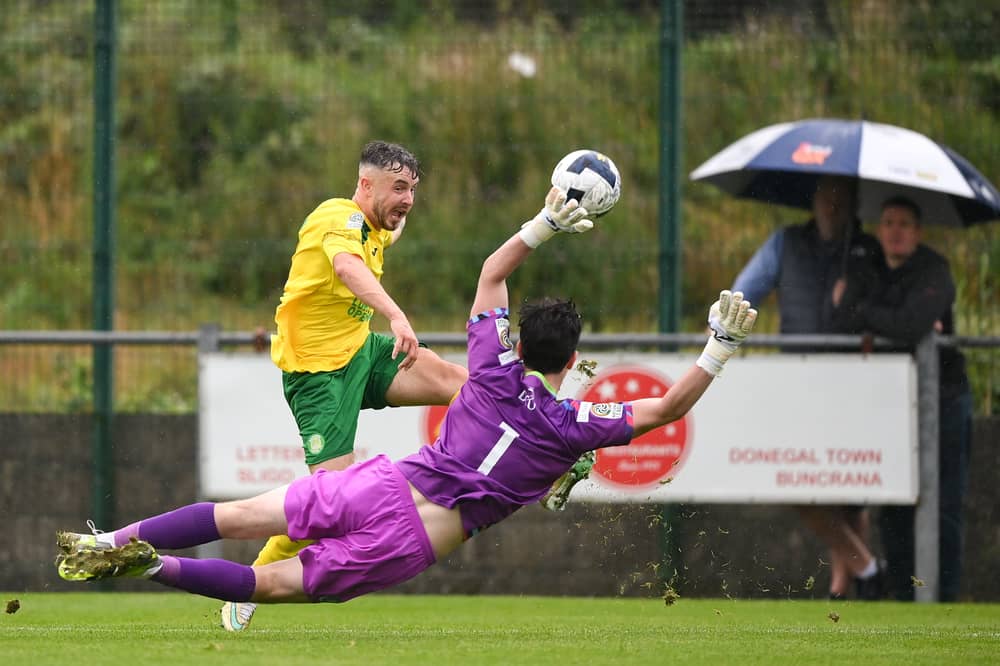 Micheál Doherty of Bonagee United in action against Home Farm DCU goalkeeper Dáithí Folan during the FAI National League Group 1 match at Dry Arch Park