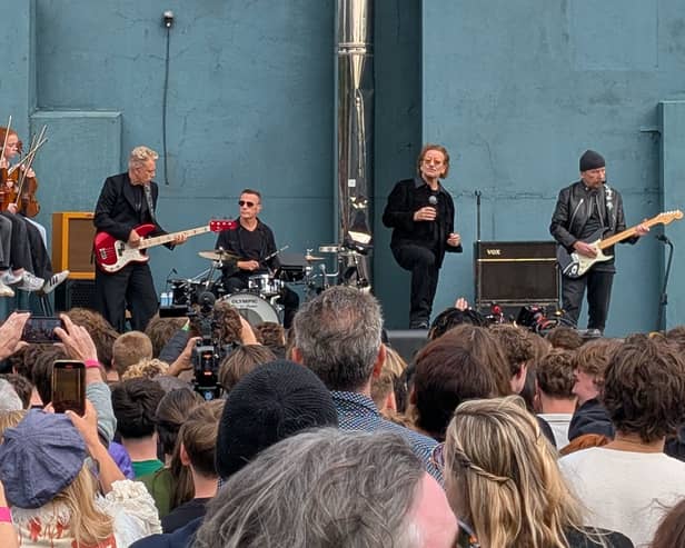 U2 during a performance in front of students from their old school in Dublin