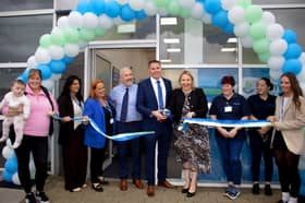 Cllr Pauric McGarvey alongside staff cutting the ribbon at the official opening