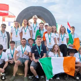 Irish Junior Surfing Team in Bundoran, with Isabella O'Reilly in the centre with Irish flag