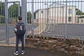 A pupil waits to get into Scoil Eoghain on Thursday morning, October 15. The Moville school was among a number across Donegal targeted by bomb hoaxers.