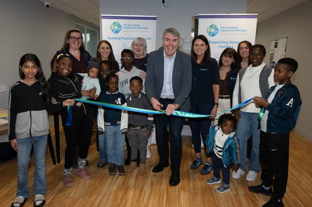 Dr. Niall Muldoon, Ireland’s Ombudsman for Children, cutting the ribbon at the official launch of the new POD Play Hub at the IPAS centre in Westside Apartments, Letterkenny.
