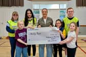 Michelle presenting the cheque at Ability Rocks