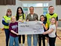 Michelle presenting the cheque at Ability Rocks