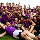 Wolfe Tones players celebrate with the Keegan Cup after their side's victory in the Meath County Senior Club Football Championship final against Donaghmore/ Ashbourne