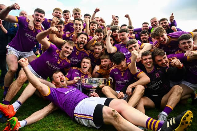 Wolfe Tones players celebrate with the Keegan Cup after their side's victory in the Meath County Senior Club Football Championship final against Donaghmore/ Ashbourne