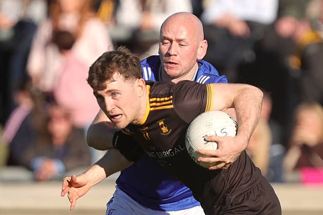 St. Eunan's Shane O'Donnell breaks away from Naomh Conaill's John O'Malley during the Senior Football Championship final in MacCumhaill Park