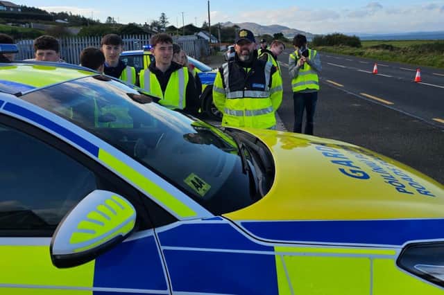Students join Buncrana gardaí during a roadside speed check operation.