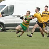 Ardara's Josh Malley breaks from defence against St. Eunan's Conor Doherty during the U-21A Football Championship in Ardara on Sunday  Photo Thomas Gallagher