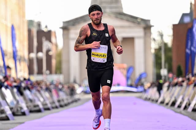 Stephen McAuley crossing the finish line at the 2026 Dublin Marathon