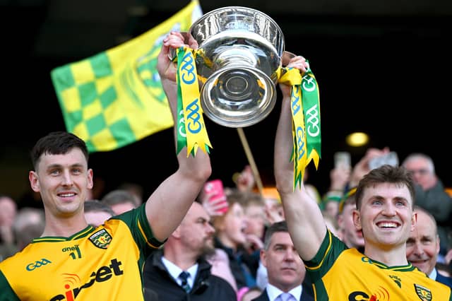 Donegal joint captains Michael Langan and Shane O'Donnell lift the Corn Mhíchíl Uí Mhuircheartaigh after their side's victory in the Division 1 final match between Kerry and Donegal at Croke Park in Dublin.