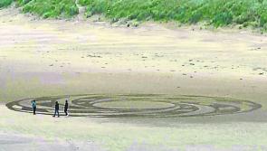 Creating sand art on Donegal beach generates great interest