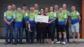 Cyclists present a cheque for €12,500 to the Donegal Hospice

