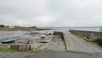 Woman and child receive medical attention as vehicle enters into sea