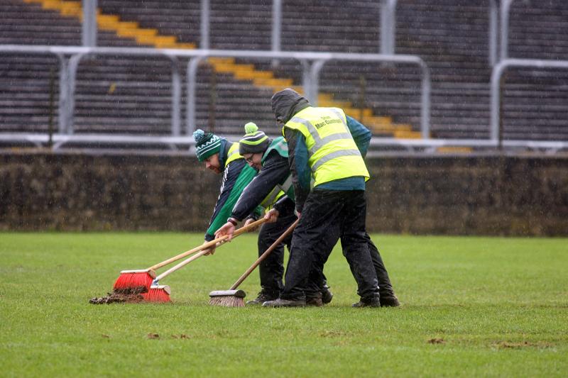Groundsmen making sure the pitch was playable at MacCumhaill Park.