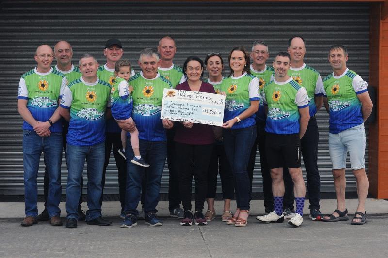 Cyclists present a cheque for €12,500 to the Donegal Hospice