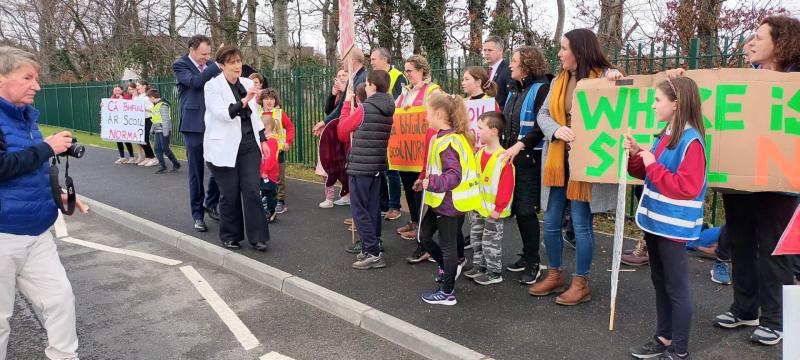 Protest greets education minister's visit to open new school
