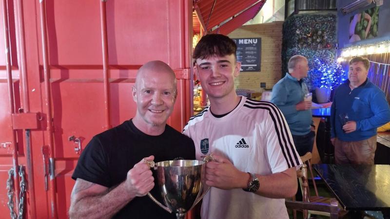 Iarlaith Duffy lifts the Donegal Youth League trophy named after his late grandad 