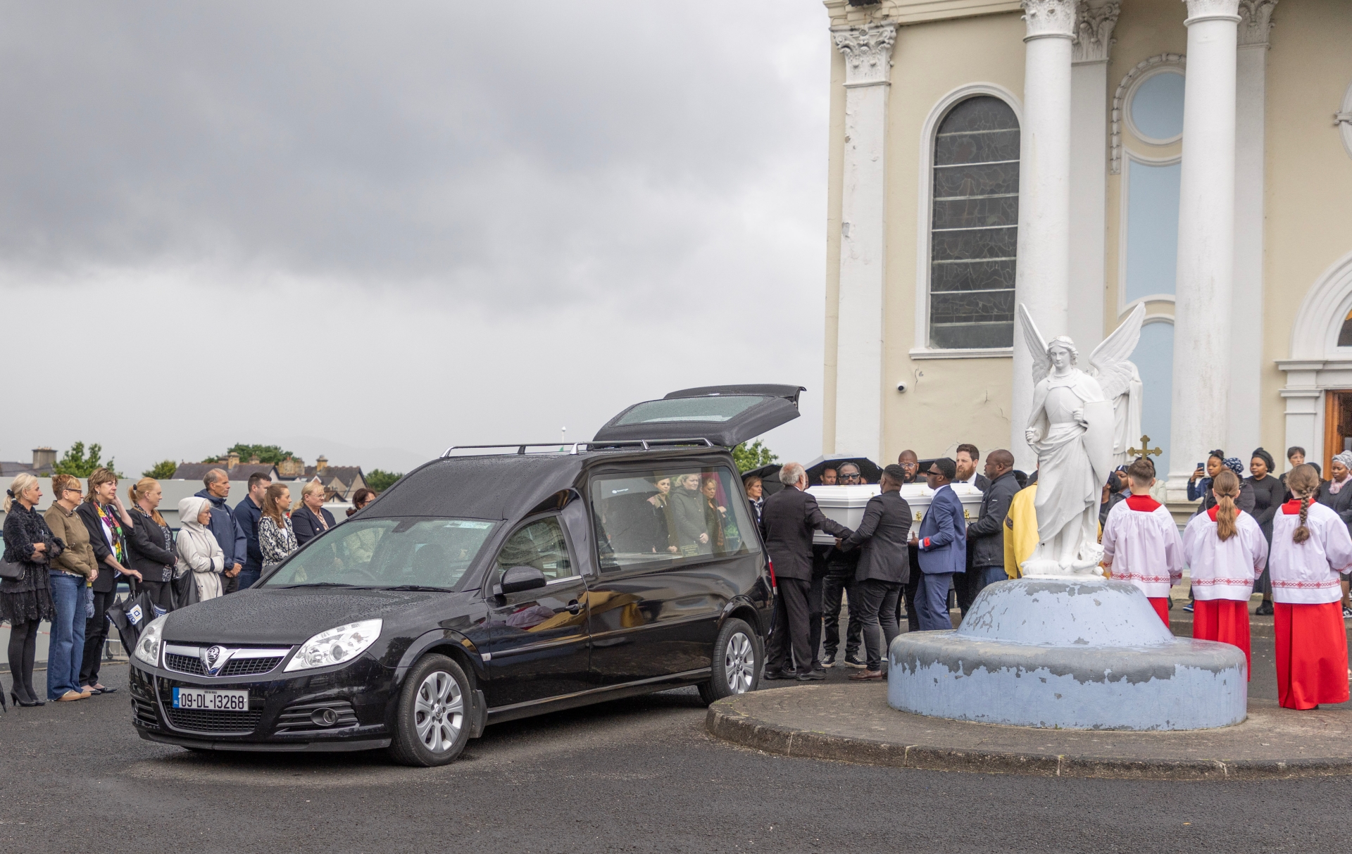 Heartbroken mourners pictured as the coffin of Matt Sibanda is carried out of the church in Buncrana.